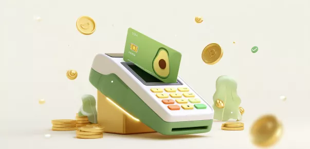 A payment terminal with a green, avocado-themed card and scattered coins